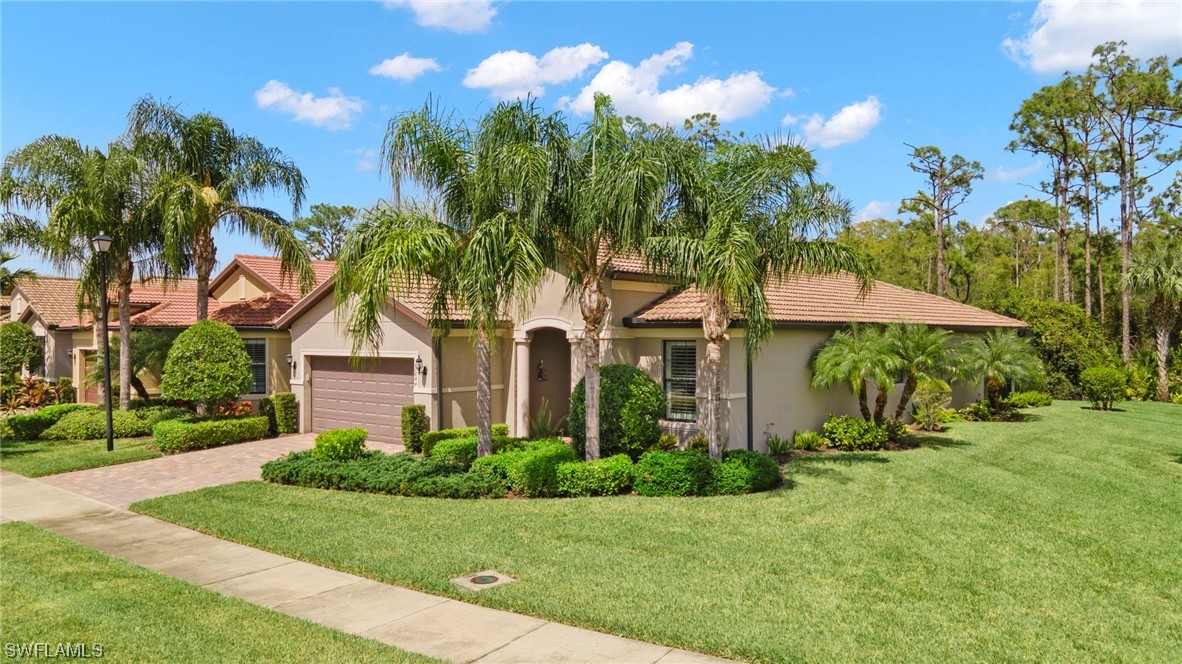 10844 Dennington Road Fort Myers, FL 33913 - Photo 26 of 50 a front view of a house with a yard and potted plants