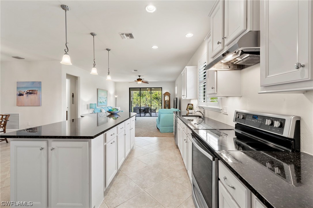 10844 Dennington Road Fort Myers, FL 33913 - Photo 5 of 50 a kitchen with stainless steel appliances sink stove top oven and cabinets