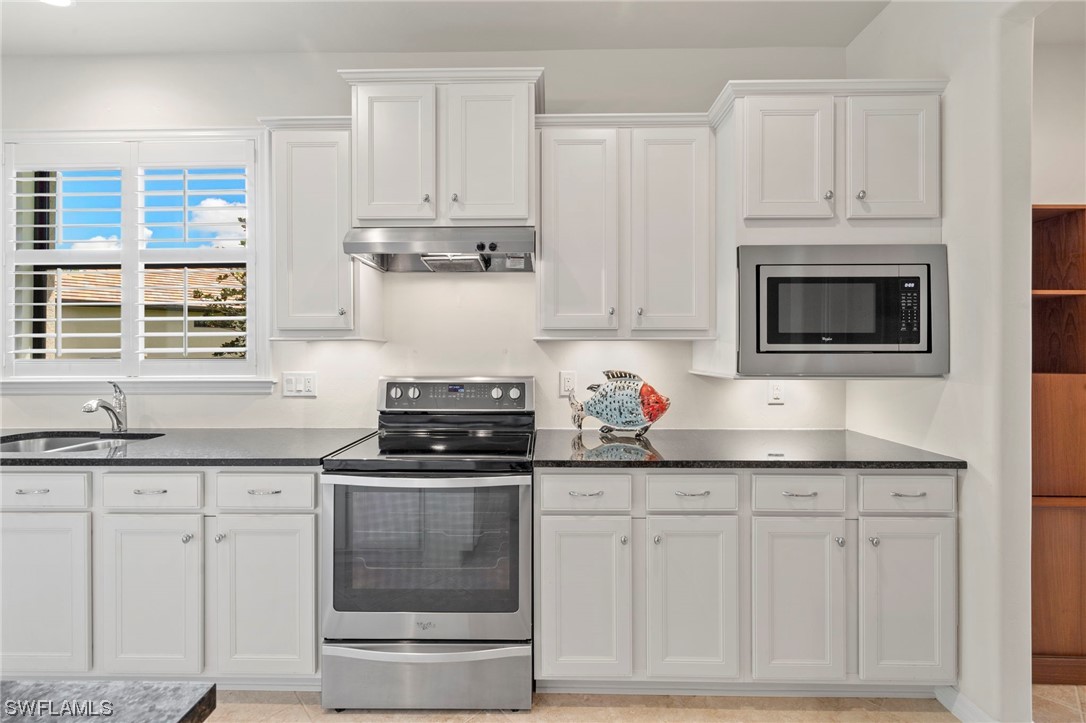 10844 Dennington Road Fort Myers, FL 33913 - Photo 6 of 50 a kitchen with granite countertop white cabinets and appliances