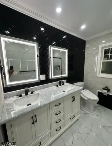 a bathroom with a double vanity sink and mirror