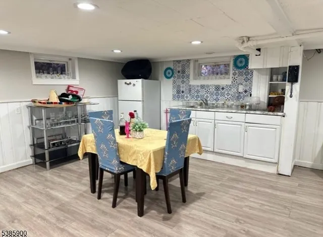 a kitchen with granite countertop a dining table chairs and cabinets