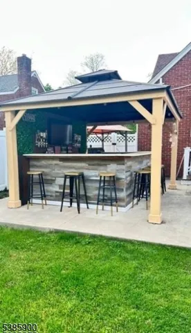 a view of house with backyard and a patio