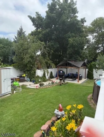 a front view of a house with swimming pool and garden