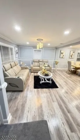 a living room with furniture and kitchen view