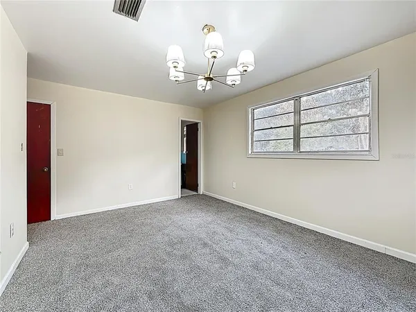 a view of an empty room with a window