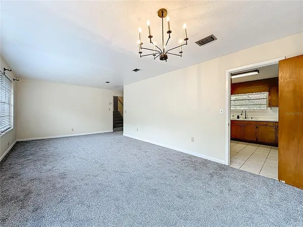 a large white kitchen with a sink and dishwasher a stove with wooden floor