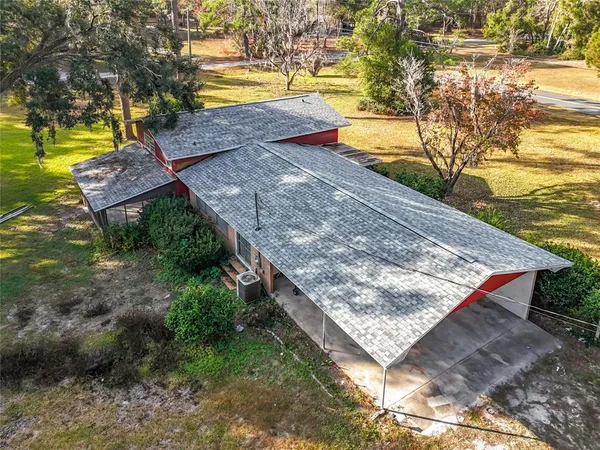 a view of a backyard with swimming pool