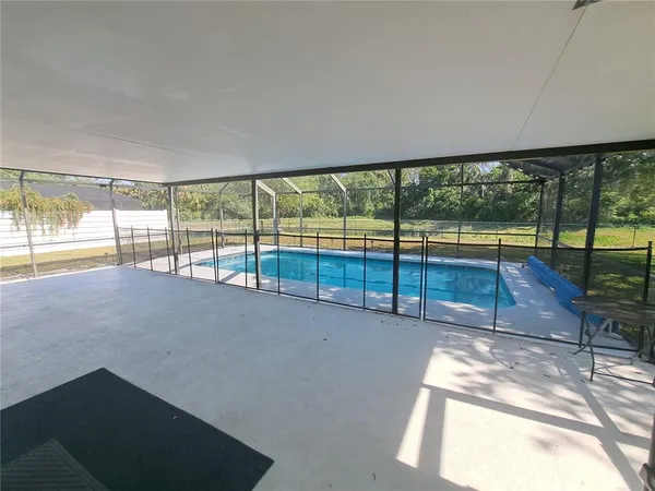 a view of an empty room with a floor to ceiling window