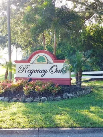 a view of a sign under a tree