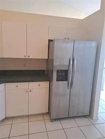 a kitchen with a refrigerator and cabinets