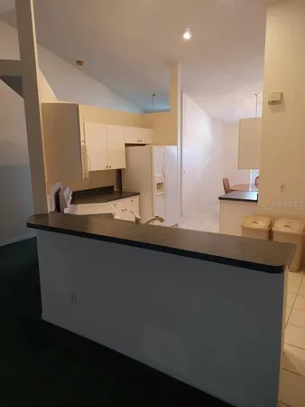 a kitchen with a sink and a refrigerator