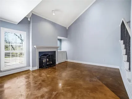 an empty room with a fireplace and window