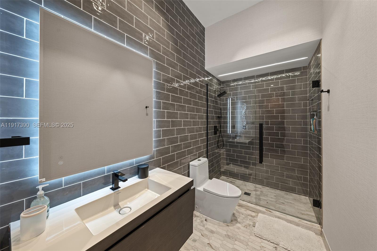 900 Washington Street Hollywood, FL 33019 - Photo 18 of 61 a bathroom with a sink mirror vanity and toilet