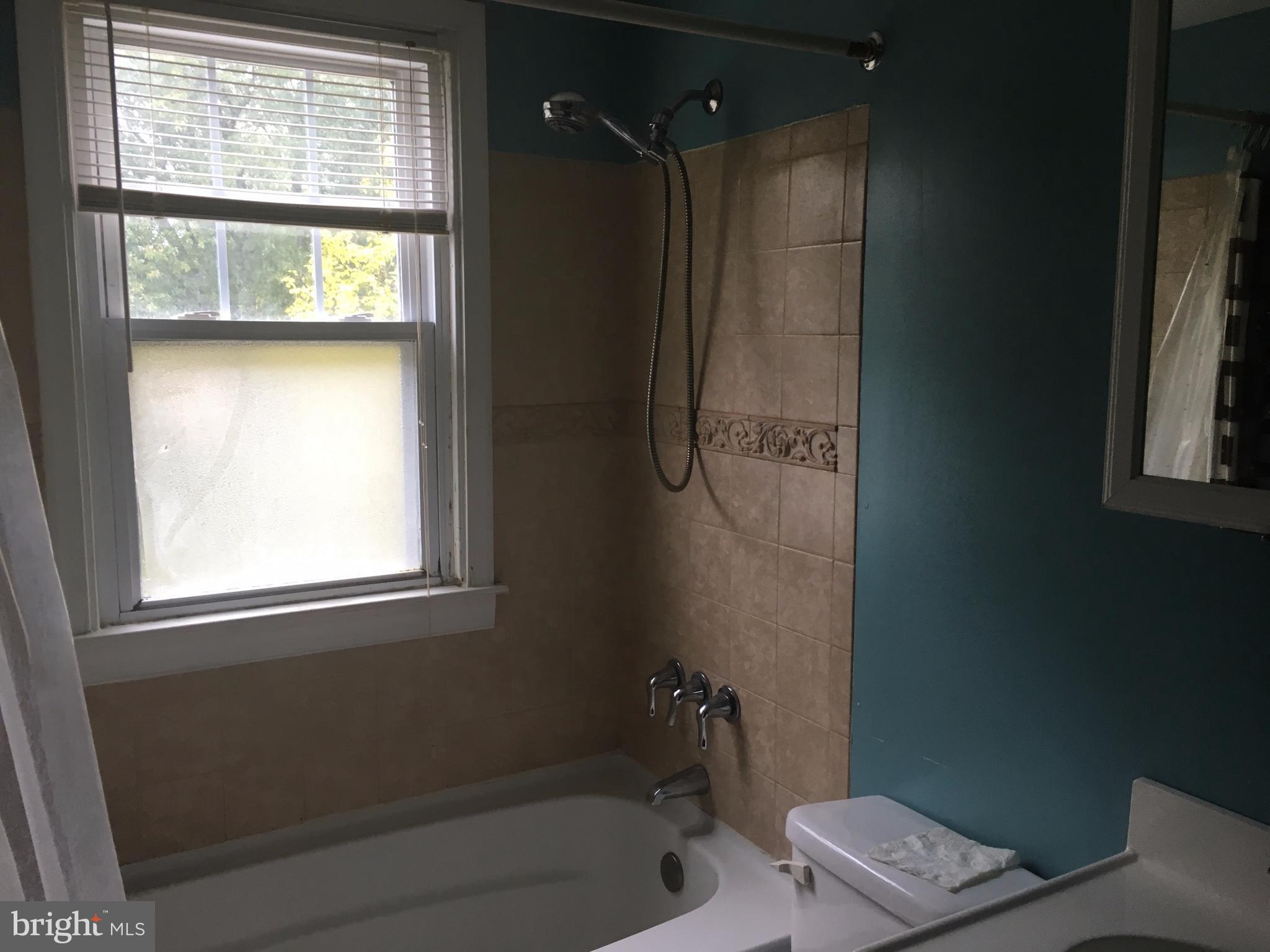 7904 Malcolm Road Clinton, MD 20735 - Photo 11 of 17 a bathroom with a bathtub and a shower