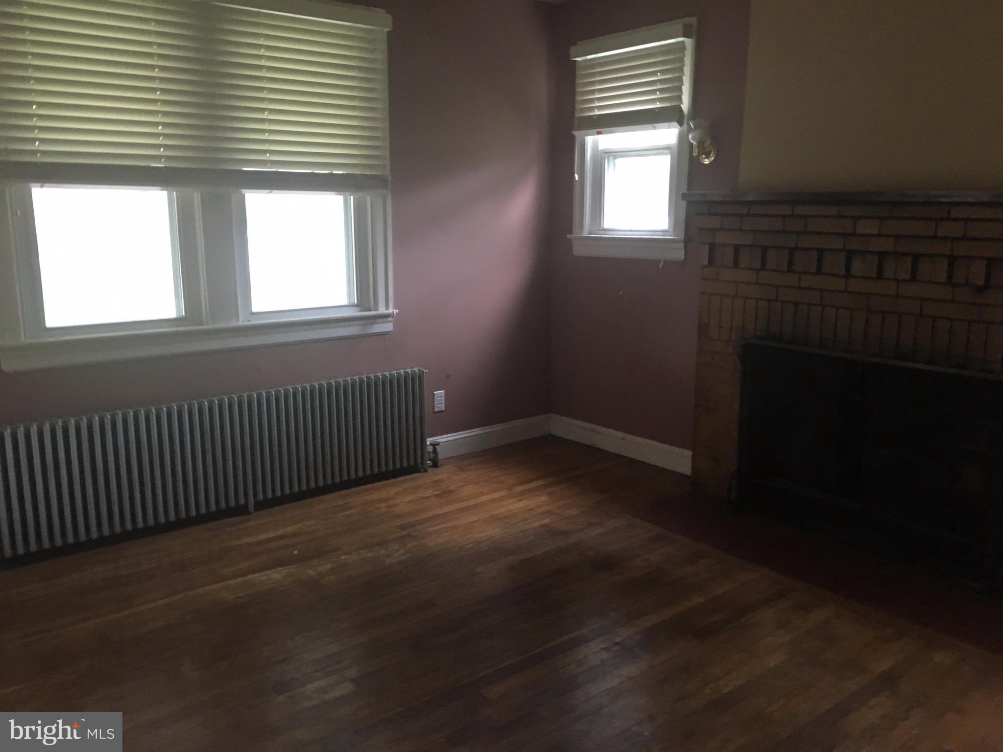 7904 Malcolm Road Clinton, MD 20735 - Photo 4 of 17 a view of an empty room with wooden floor and a window
