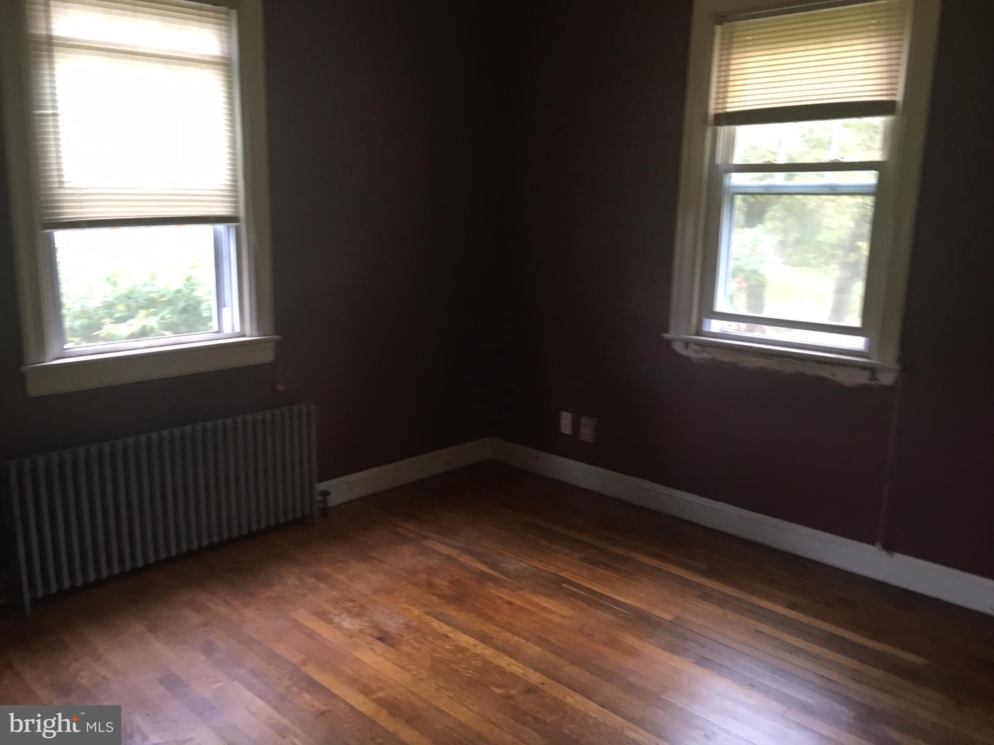 7904 Malcolm Road Clinton, MD 20735 - Photo 5 of 17 a view of an empty room with wooden floor and a window