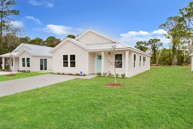 a view of a house with a backyard