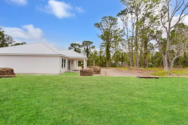 a view of a house with a backyard