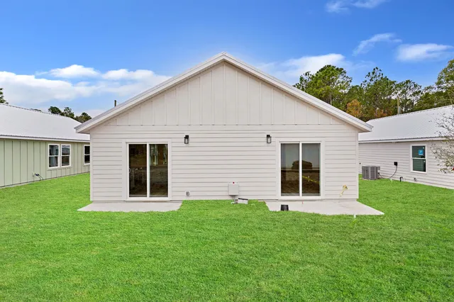 a view of a house with a backyard