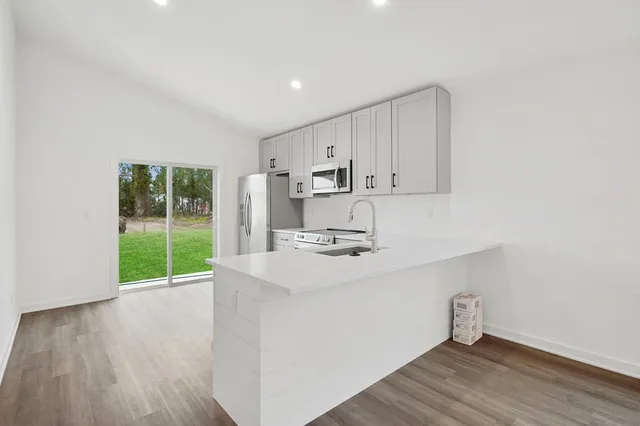 a view of kitchen with wooden floor