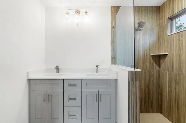 a bathroom with a double vanity sink and mirror