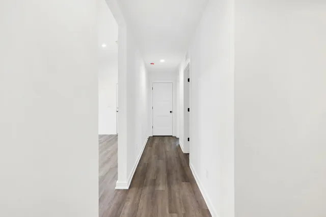 a view of a hallway with wooden floor