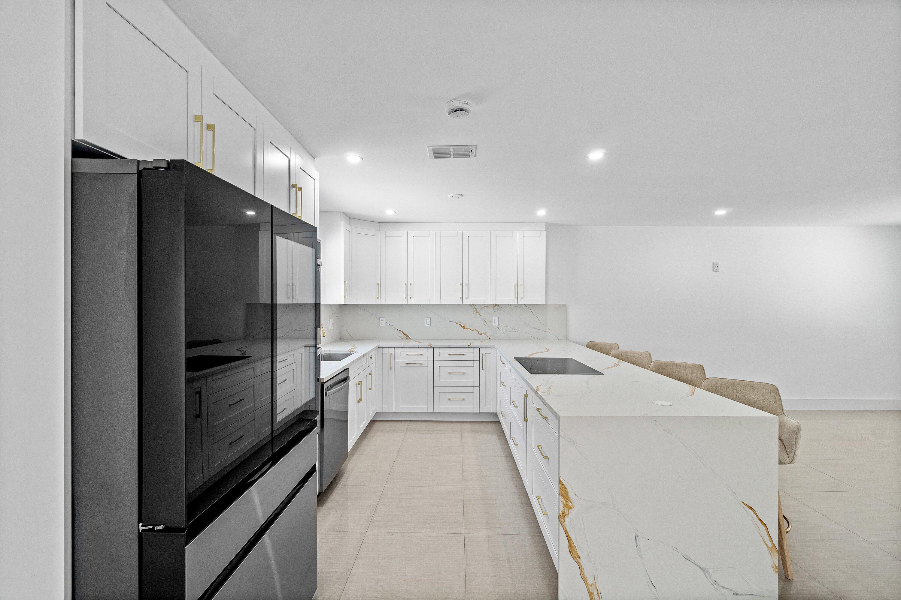 1531 Northwest 4th Street Boca Raton, FL 33486 - Photo 7 of 34 a kitchen with a refrigerator and a sink