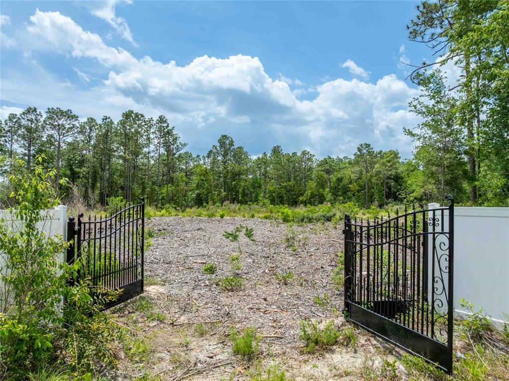 15022 Gar Street Spring Hill, FL 34609 - Photo 2 of 26 a view of a wrought iron fences in front of yard