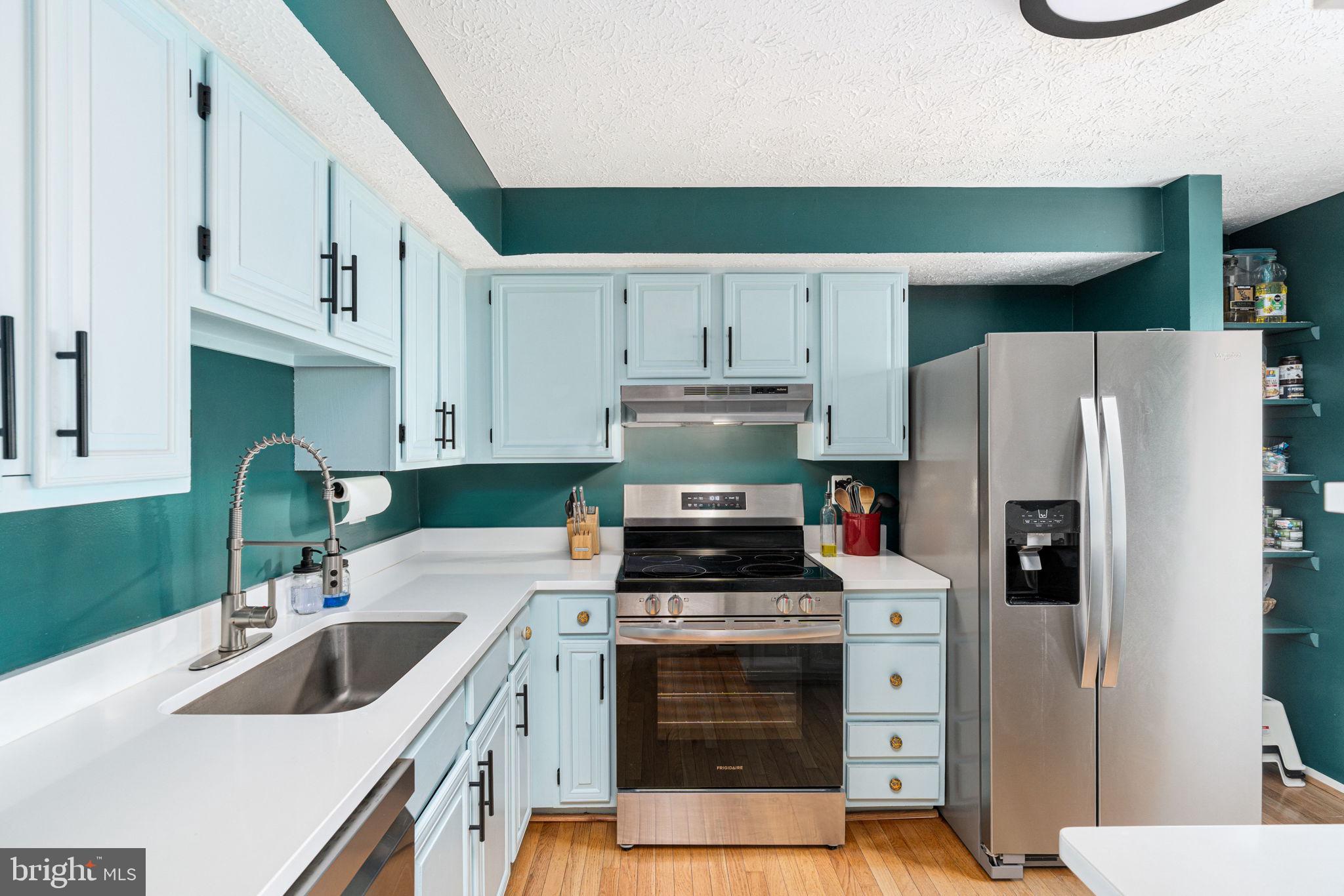 11537 Ivy Bush Court Reston, VA 20191 - Photo 14 of 49 a kitchen with white cabinets and stainless steel appliances