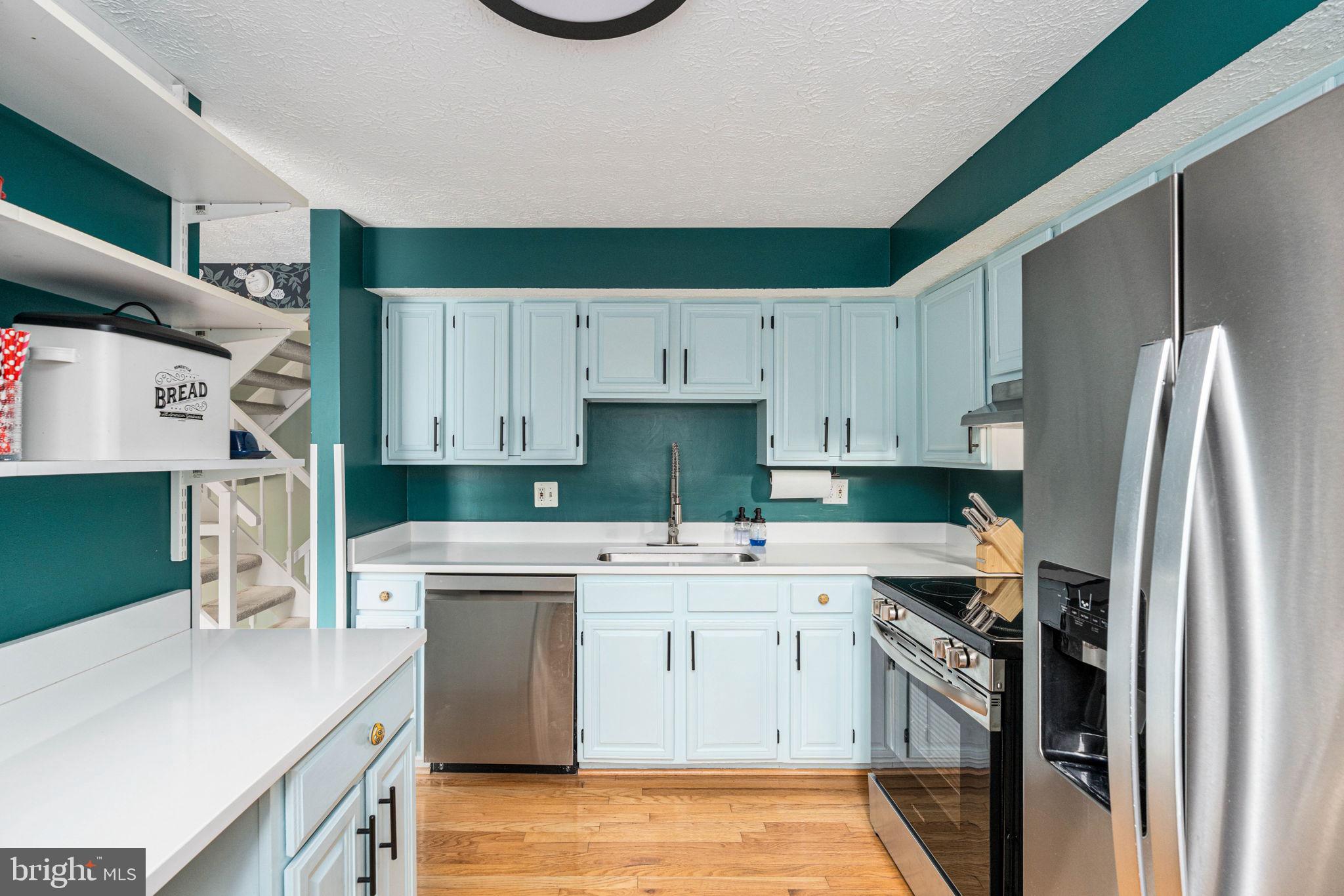 11537 Ivy Bush Court Reston, VA 20191 - Photo 15 of 49 a kitchen with a sink a stove and refrigerator