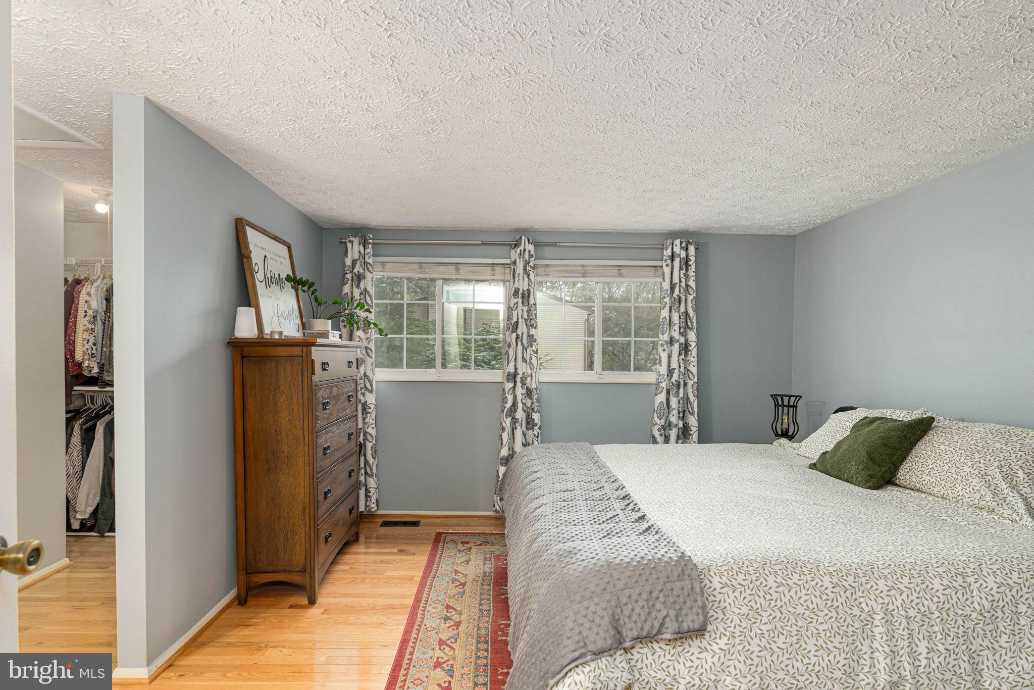 11537 Ivy Bush Court Reston, VA 20191 - Photo 20 of 49 a bedroom with a large bed and a large window