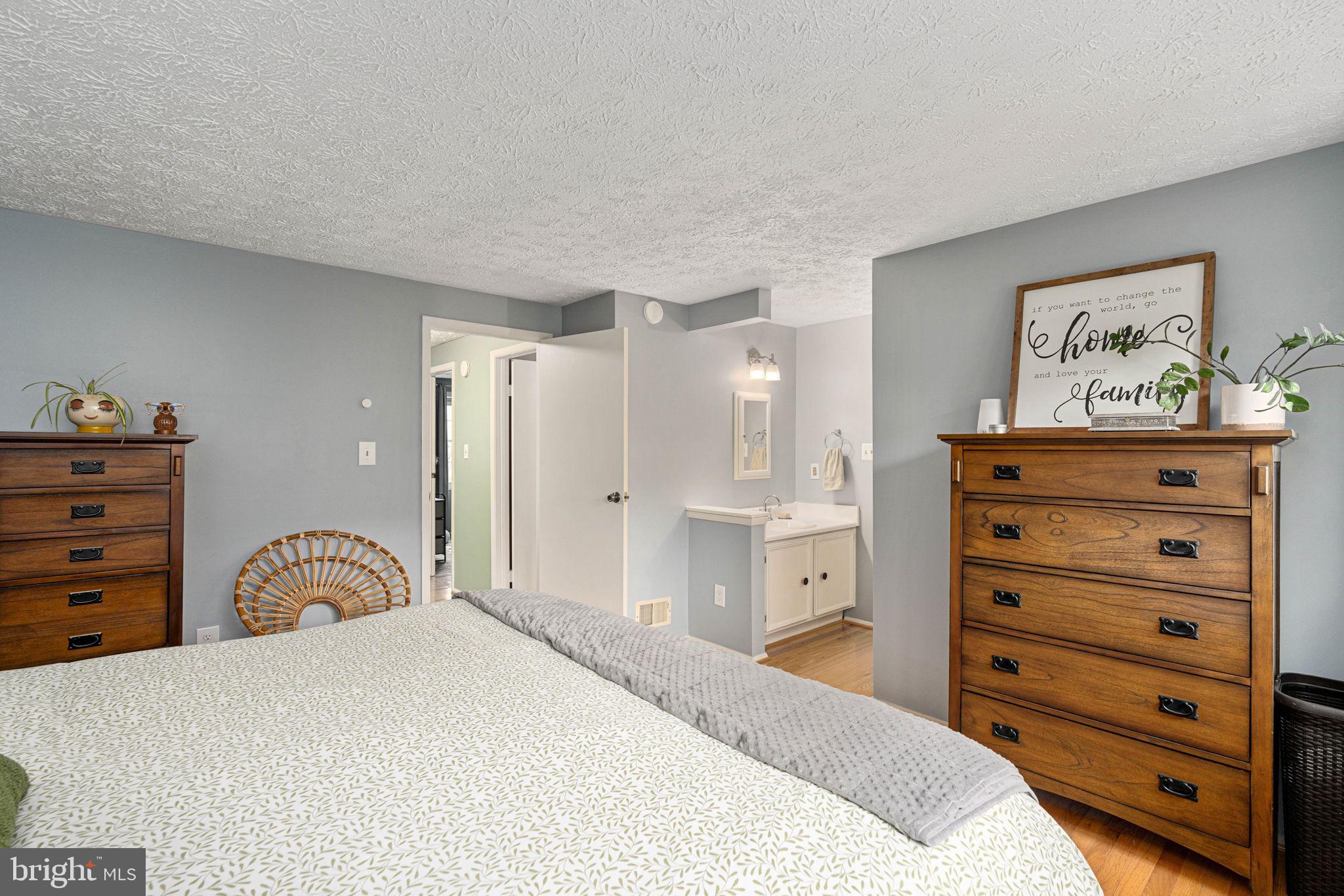 11537 Ivy Bush Court Reston, VA 20191 - Photo 22 of 49 a bedroom with a bed and a dresser