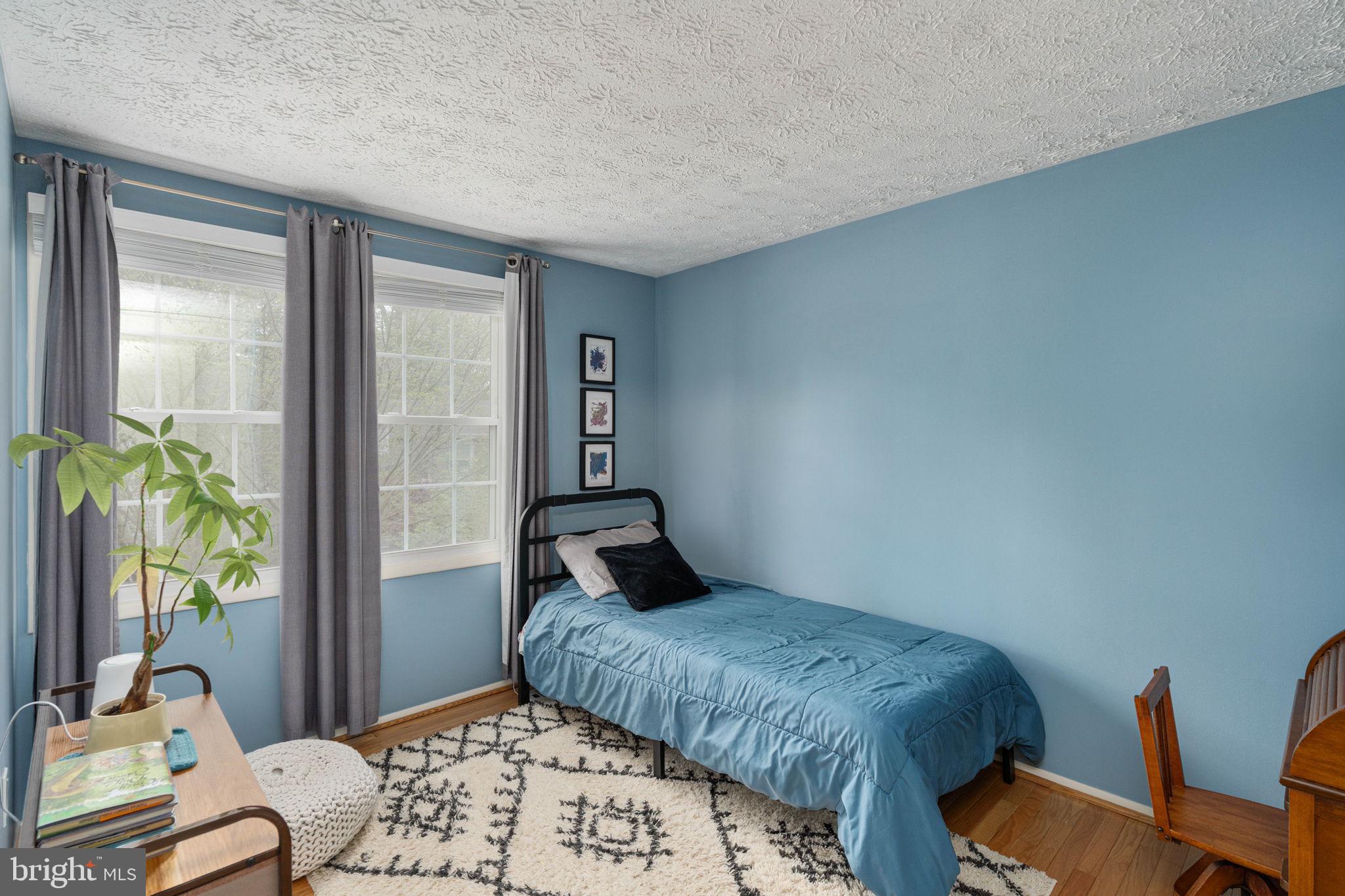 11537 Ivy Bush Court Reston, VA 20191 - Photo 25 of 49 a bedroom with a bed and wooden floor