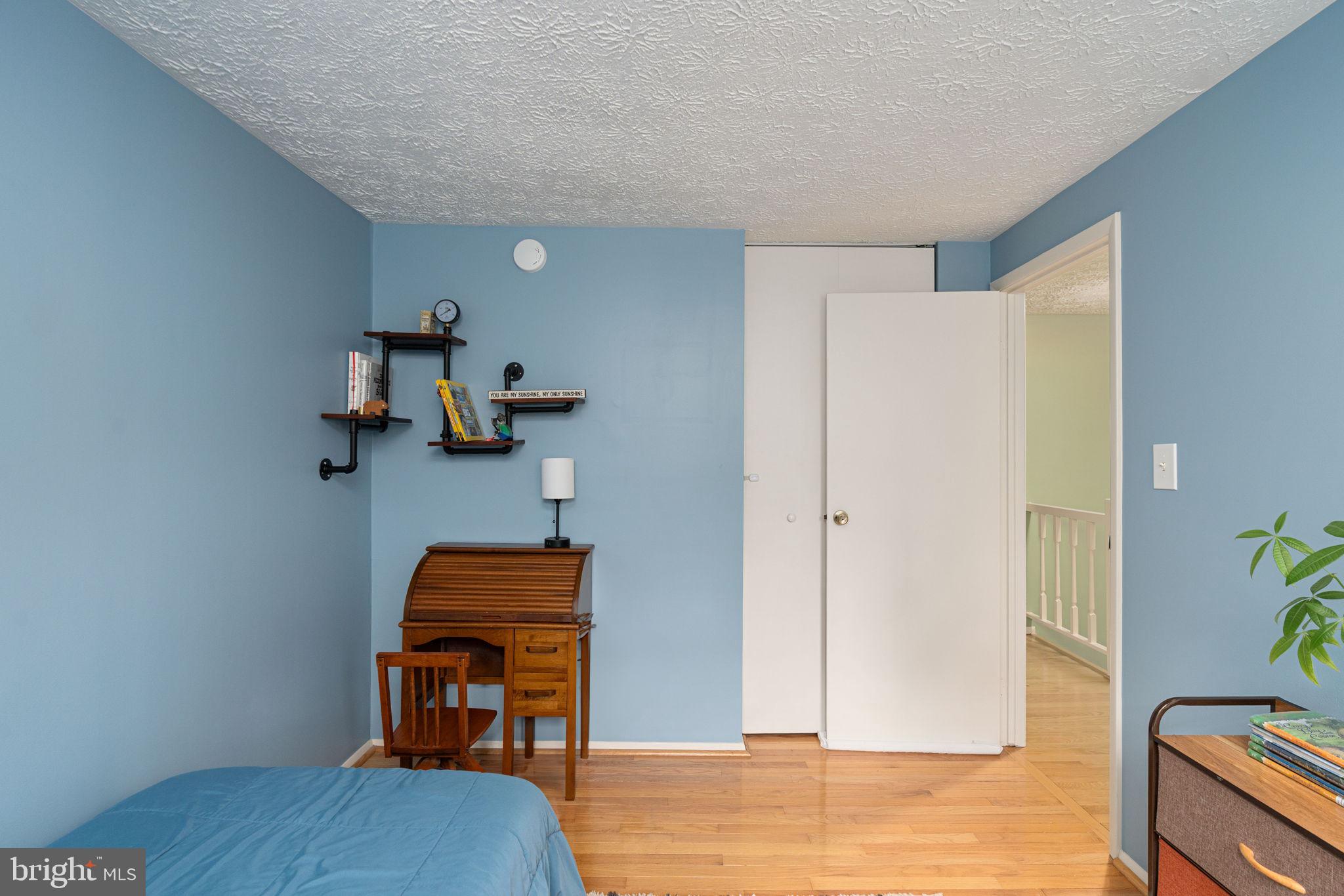 11537 Ivy Bush Court Reston, VA 20191 - Photo 27 of 49 a bedroom with a bed and wooden floor