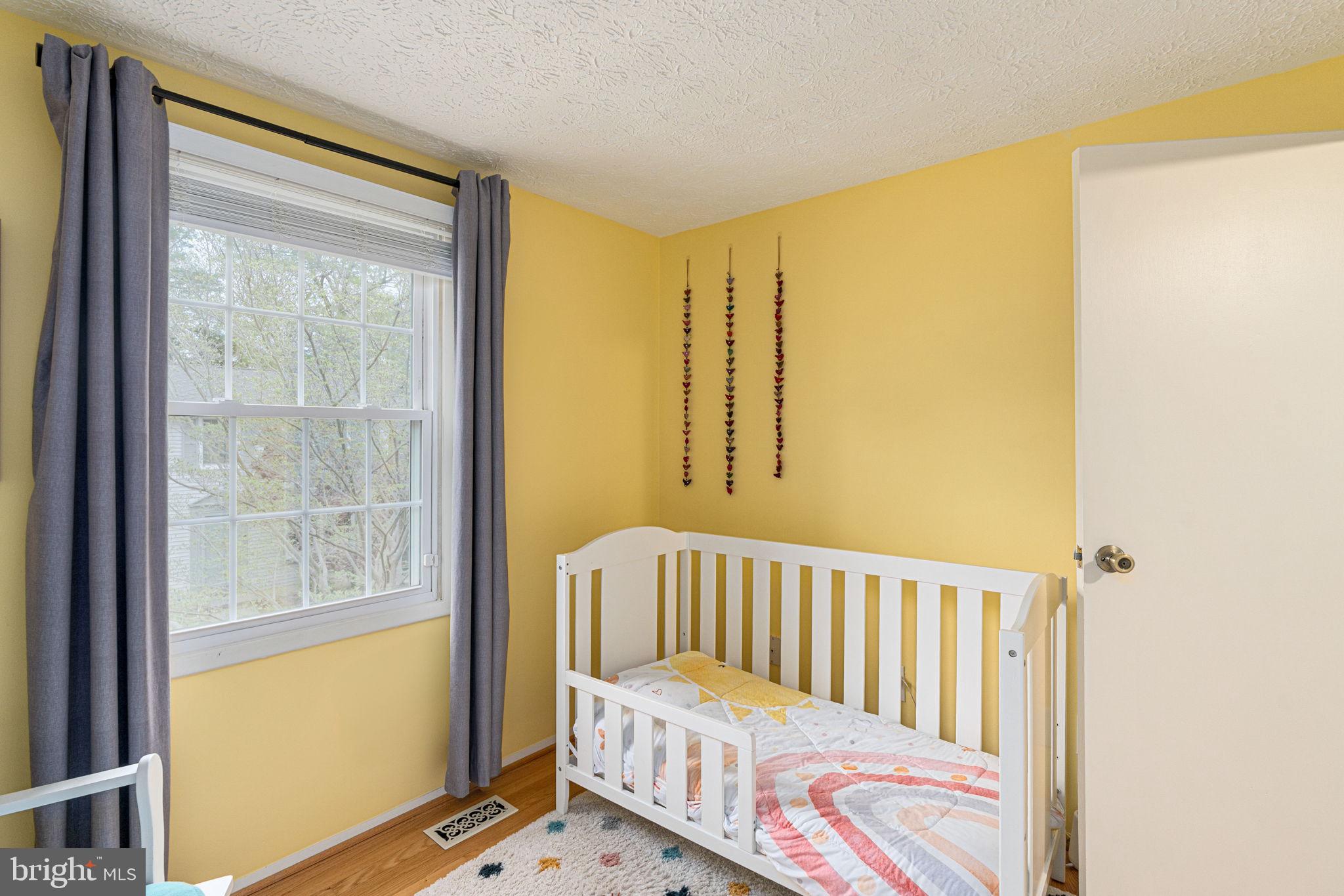 11537 Ivy Bush Court Reston, VA 20191 - Photo 29 of 49 a view of a bedroom with wooden floor & a window