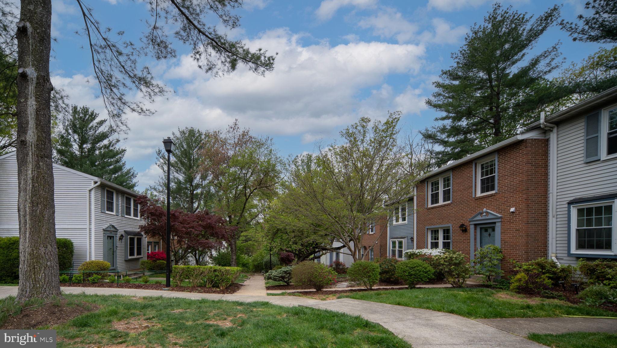 11537 Ivy Bush Court Reston, VA 20191 - Photo 3 of 49 a view of a brick house next to a yard with big trees