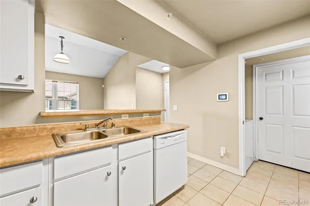 a kitchen with cabinets and white appliances