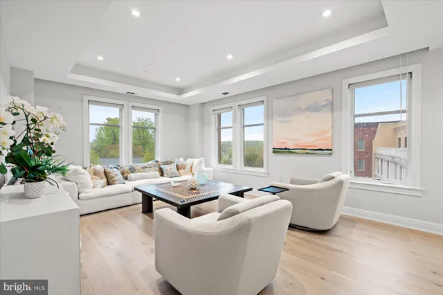 a living room with furniture and large windows