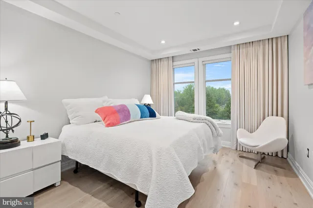 a bedroom with a bed and a large window