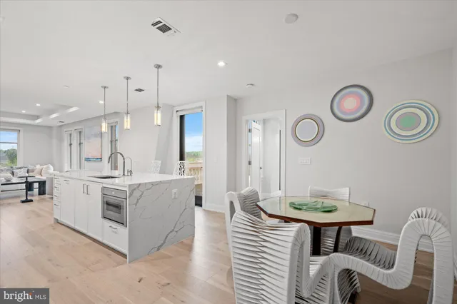 a large kitchen with a table and chairs