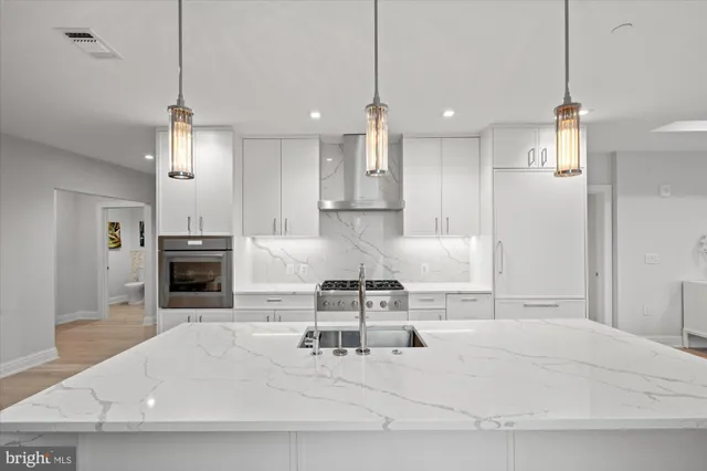 a living room with furniture a fireplace and kitchen view