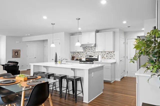 a kitchen with a table and chairs in it