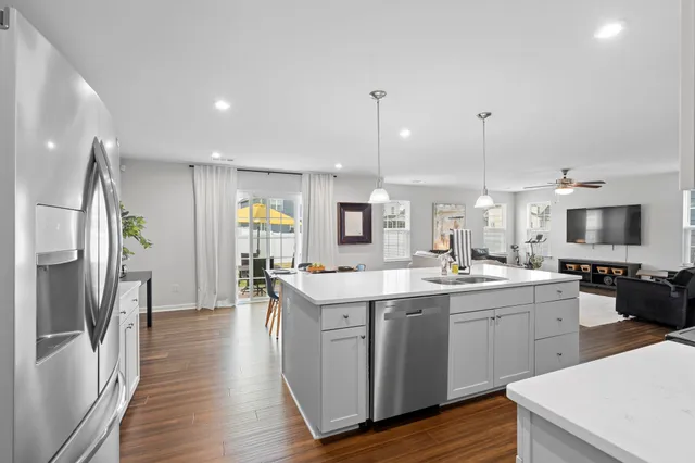 a kitchen with a sink stainless steel appliances and cabinets