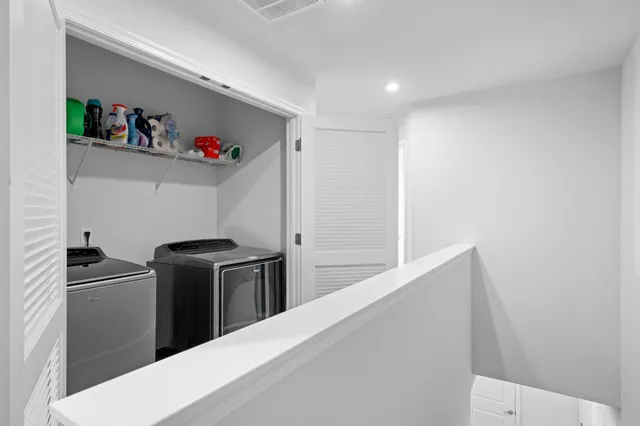 a kitchen with refrigerator and cabinets