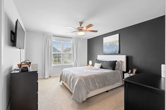 a bedroom with a bed and a chandelier