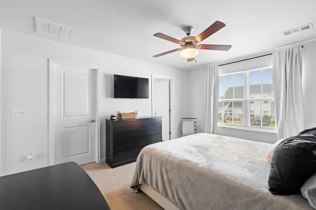 a bedroom with a large bed and a flat screen tv