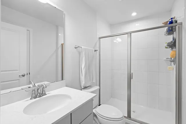 a bathroom with a sink toilet and shower