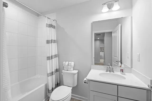 a bathroom with a sink toilet vanity and shower