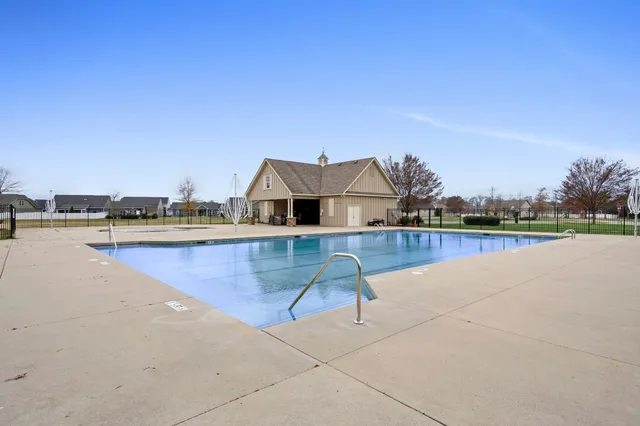 a view of a swimming pool and lounge chair