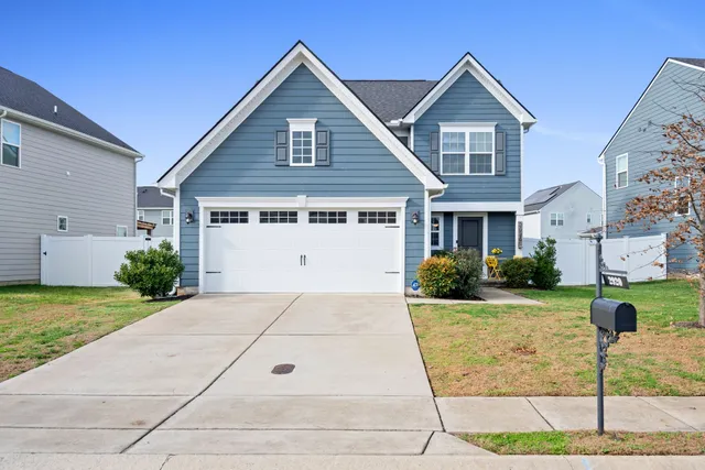 a view of a yard in front view of a house